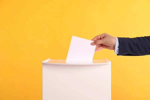 Woman Putting Her Vote Ballot Box Orange Background Closeup — Stock Photo, Image