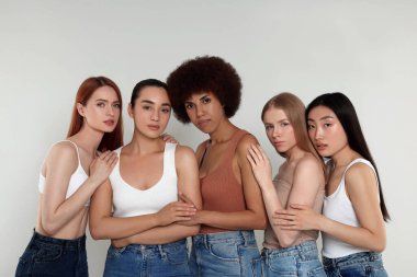 Açık gri arka planda güzel genç kadınların portresi