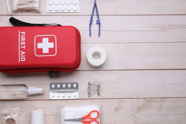 stock image Flat lay composition with first aid kit on wooden table, space for text