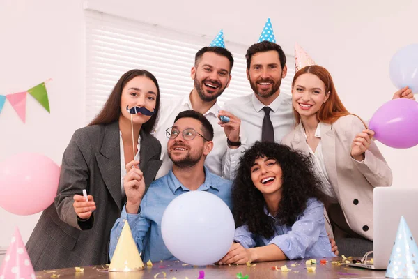 Coworkers having fun during office party indoors