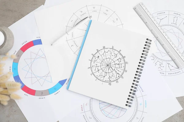 stock image Zodiac wheels and natal chart for making astrological predictions on table, flat lay