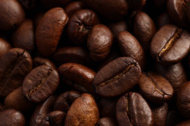Aromatic roasted coffee beans as background, closeup clipart