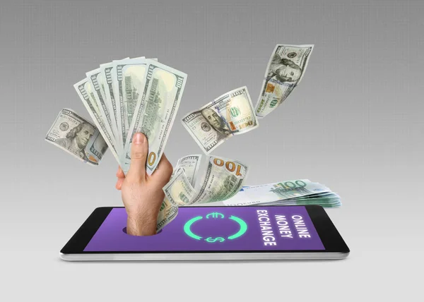 Online money exchange. Mobile phone application and euro banknotes on grey background. Hand with dollars sticking out of device