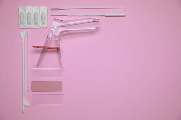 Sterile gynecological examination kit and medicaments on pink background, flat lay. Space for text