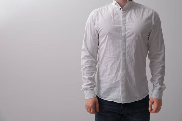 Man wearing rumpled shirt on white background, closeup