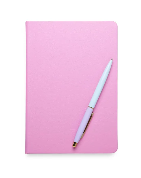 Closed pink office notebook and pen isolated on white, top view