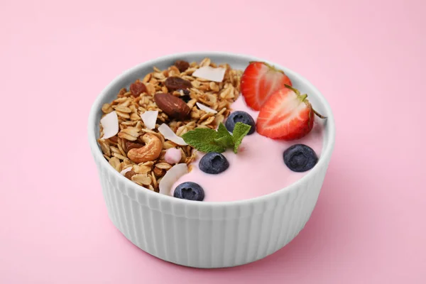 味道鲜美的格拉诺拉 酸奶和新鲜的浆果在粉红背景的碗里 健康早餐 — 图库照片