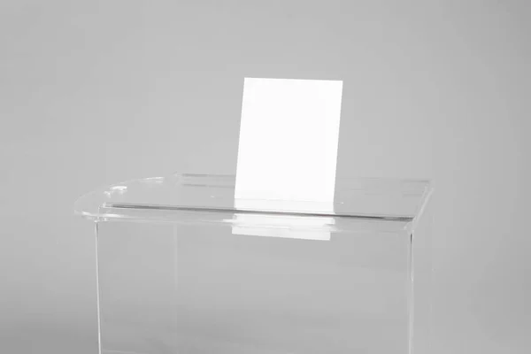 Ballot box with vote on light grey background, closeup. Election time