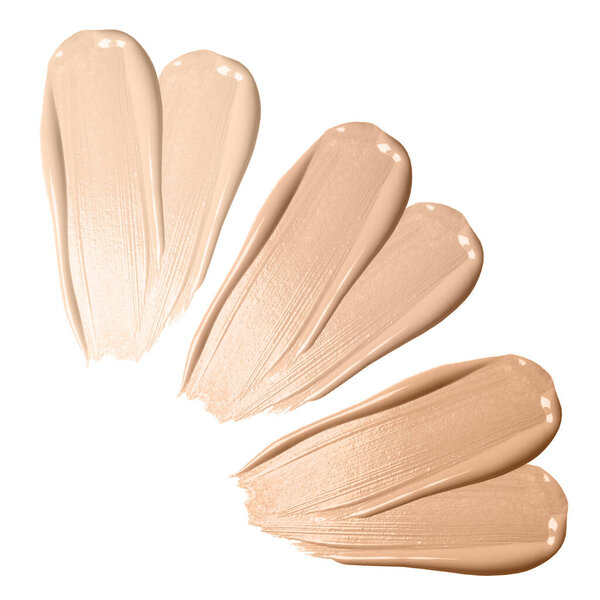 Set of foundation samples in different tones on white background