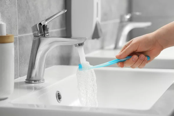Woman Washing Plastic Toothbrush Flowing Water Faucet Bathroom Closeup — Stock Photo, Image