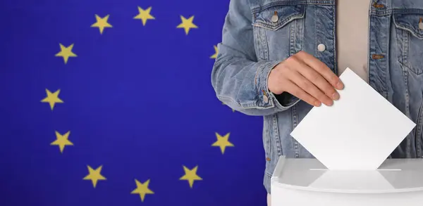 Man putting his vote into ballot box against flag of Europe, closeup. Banner design with space for text