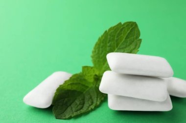Lezzetli beyaz sakız ve nane yaprakları yeşil arka planda, yakın plan