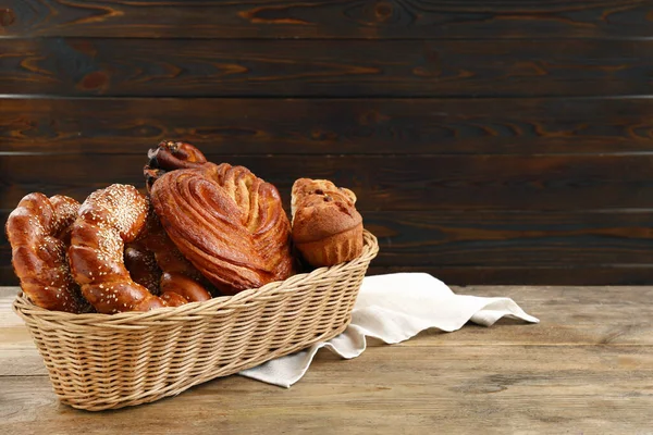 Wicker Basket Different Tasty Freshly Baked Pastries Wooden Table Space — Stock Photo, Image