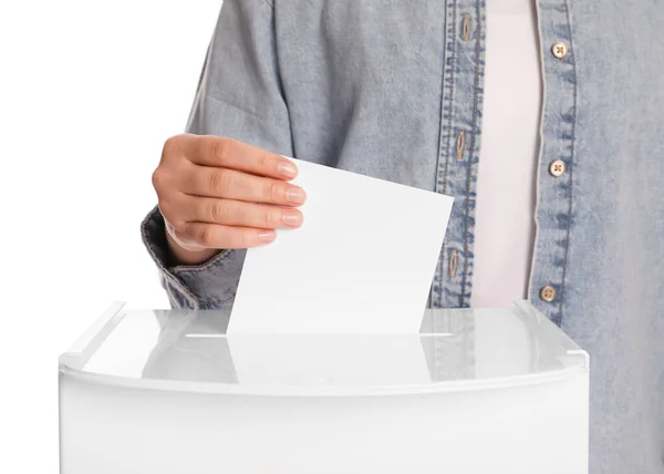 Woman putting her vote into ballot box on white background, closeup