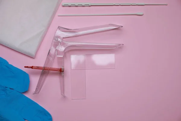 Sterile gynecological examination kit on pink background, flat lay. Space for text