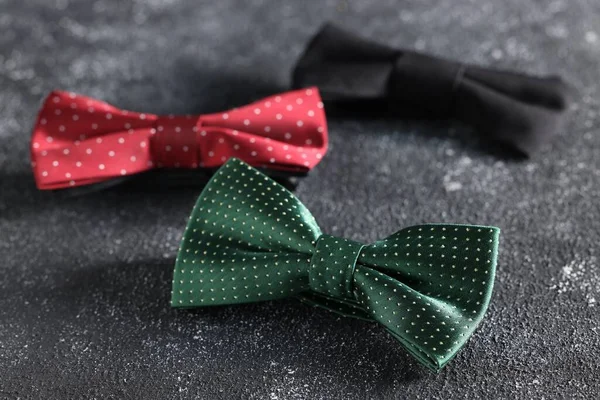 Stylish Color Bow Ties Black Textured Background Closeup — Stock Photo, Image