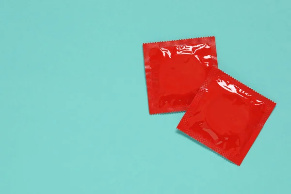 Condom Packages Turquoise Background Flat Lay Space Text Safe Sex — Stock Photo, Image