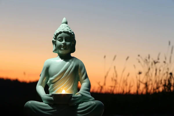 Decorative Buddha Statue Burning Candle Outdoors Sunset Space Text — Stock Photo, Image