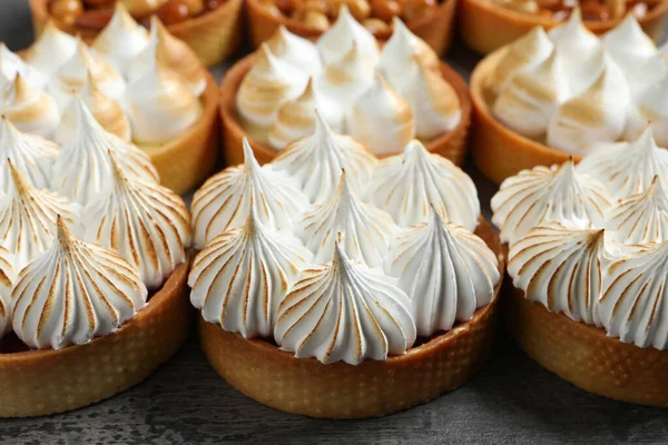 stock image Many different tartlets on dark grey table, closeup. Tasty dessert