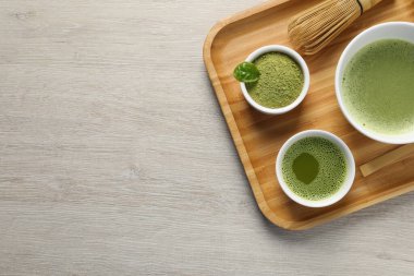 Taze kibrit çayı, bambu çırpısı ve ahşap masada yeşil toz, üst manzara. Metin için boşluk