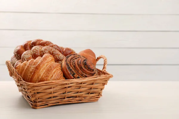 Wicker Basket Different Tasty Freshly Baked Pastries White Table Space — Stock Photo, Image