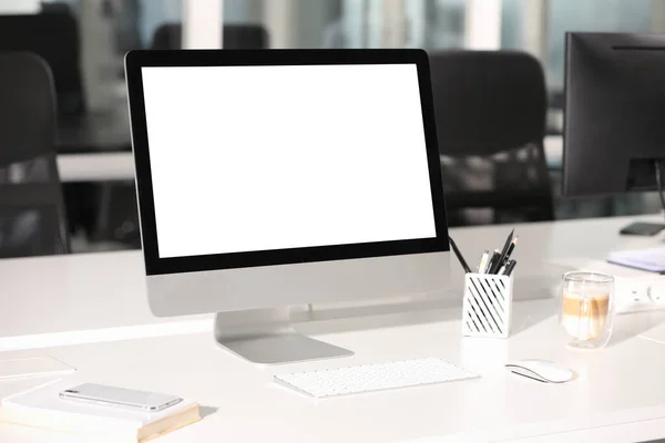 Modern computer on white desk in office. Mockup for design