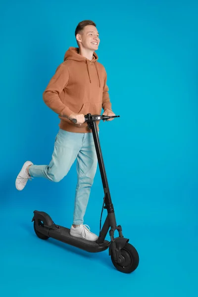 Happy Man Riding Modern Electric Kick Scooter Light Blue Background — Stock Photo, Image