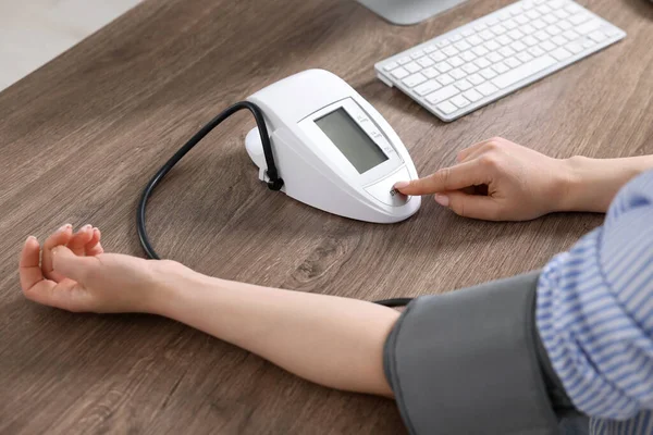 Woman Measuring Blood Pressure Wooden Table Closeup — Stock Photo, Image