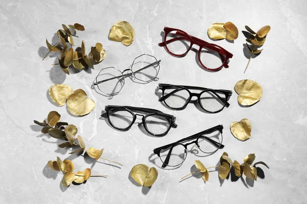 Many Glasses Stylish Frames Leaves Grey Marble Table Flat Lay — Stock Photo, Image