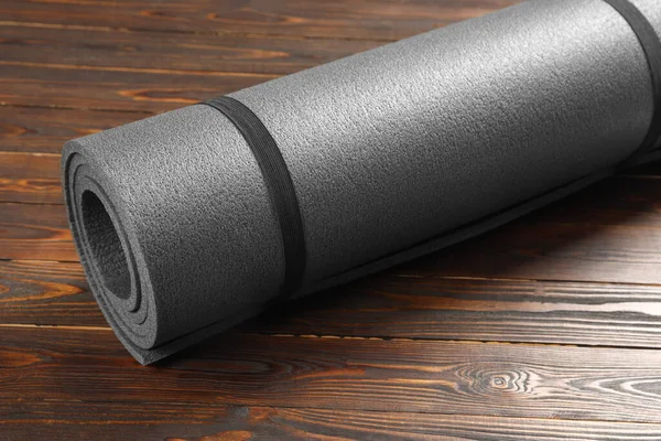 One grey yoga mat on wooden floor