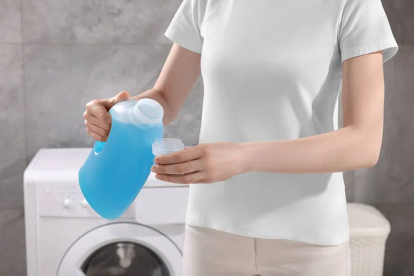Woman Pouring Fabric Softener Bottle Cap Washing Clothes Indoors Closeup — Stock Photo, Image