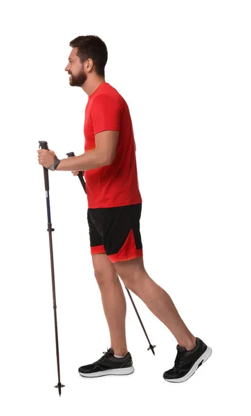 stock image Man practicing Nordic walking with poles isolated on white