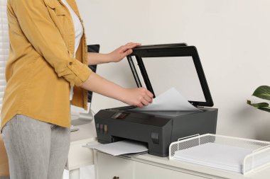 Woman using modern printer at home, closeup clipart