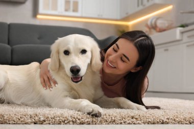 Evde şirin Labrador Retriever köpeği olan mutlu bir kadın. Sevimli hayvan.