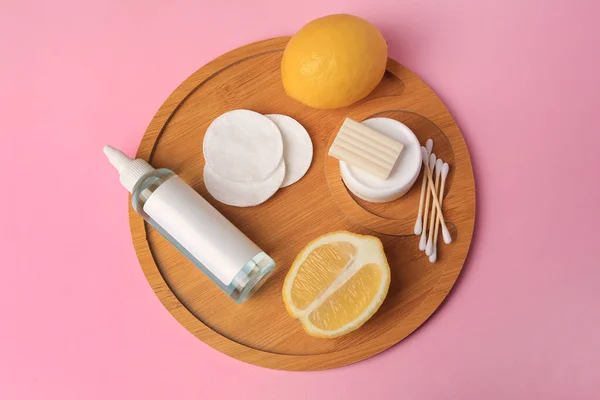 Lemon face cleanser. Fresh citrus fruits and personal care products on pink background, top view