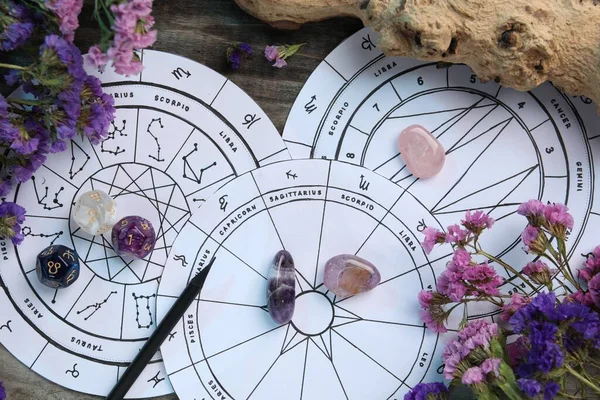 Flat lay composition with zodiac wheels and astrology dices on wooden table