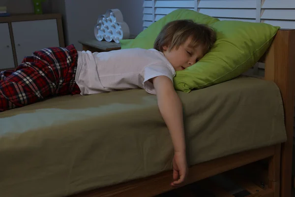Little boy snoring while sleeping in bed at night