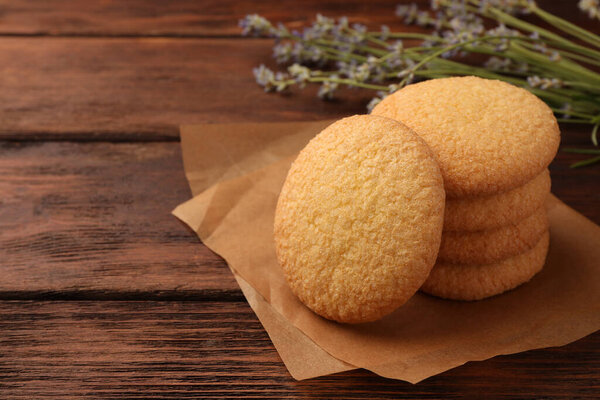 Delicious Danish butter cookies on wooden table, closeup. Space for text