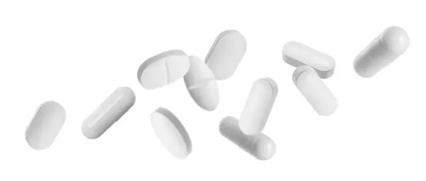 Viele Verschiedene Pillen Fallen Auf Weißem Hintergrund — Stockfoto