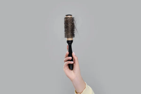 Woman Holding Brush Lost Hair Grey Background Closeup Alopecia Problem — Stock Photo, Image