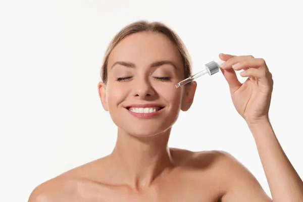 Beautiful Woman Applying Cosmetic Serum Her Face White Background — Stock Photo, Image