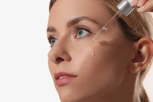 Beautiful Woman Applying Cosmetic Serum Her Face White Background Closeup — Stock Photo, Image