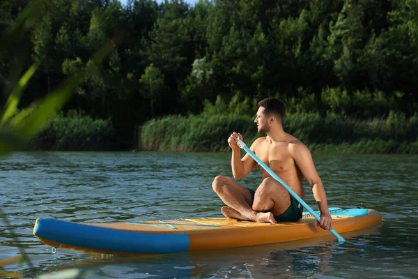 男子划桨板在河上的Sup板上 — 图库照片