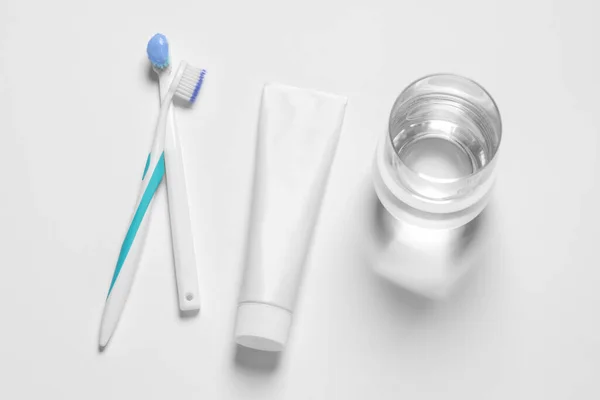 Plastic Toothbrushes Paste Glass Water White Background Top View — Stock Photo, Image