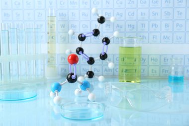Işık yüzeyinde moleküler model ve laboratuvar ekipmanları