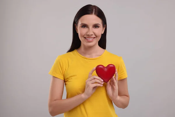 Happy Young Woman Holding Red Heart Grey Background — Stock Photo, Image