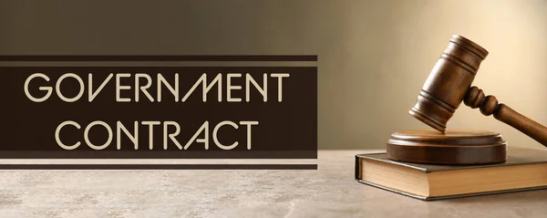 Words Government Contract and wooden gavel on table, banner design