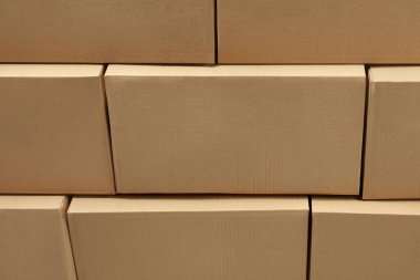 Arkaplan olarak birçok kapalı karton kutu yığını