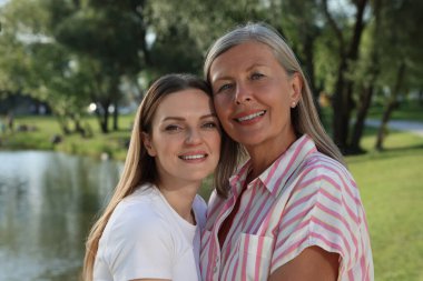 Parktaki mutlu anne ve kızın aile portresi.