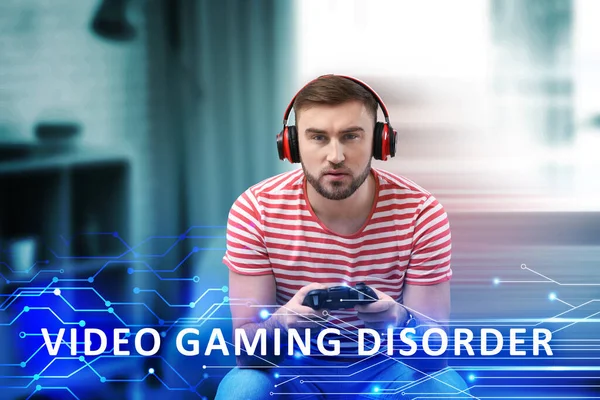 Gaming disorder. Man with headphones playing at home. Circuit board pattern with text